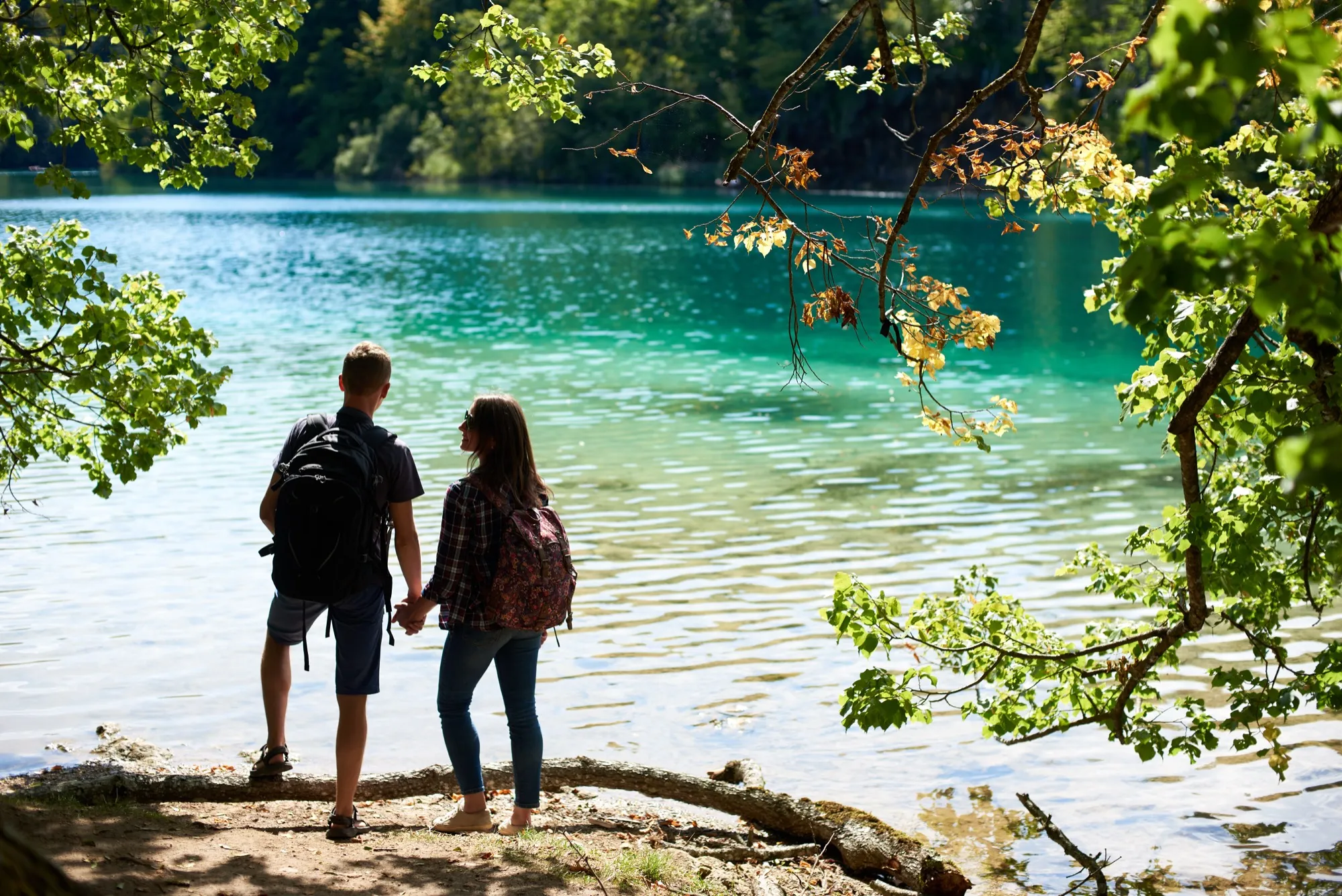 Visitors by a turquoise lake