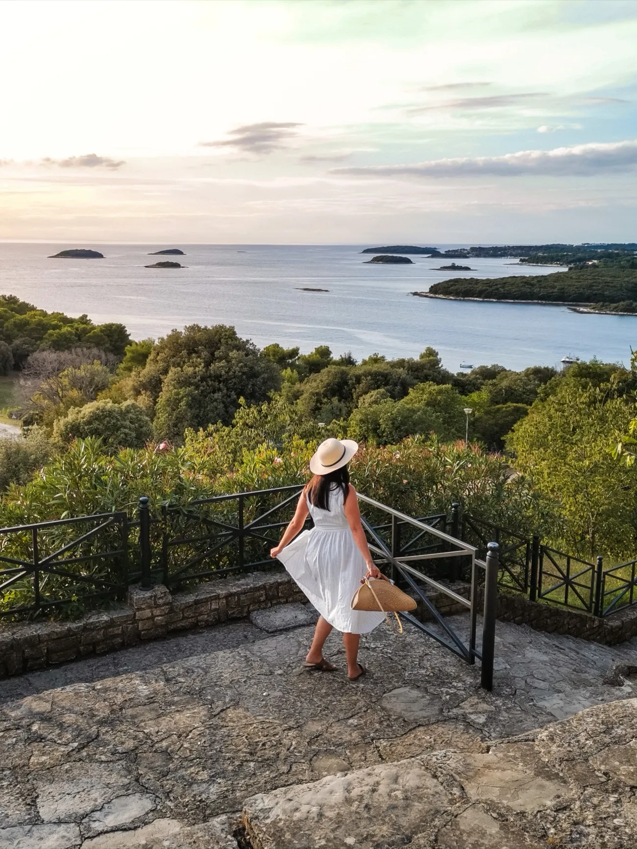 Visitor on a stone viewpoint above the sea
